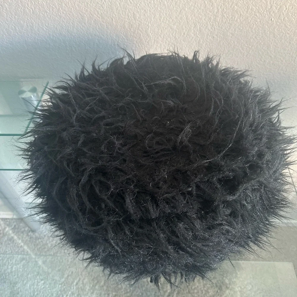 black faux fur ottoman/stool with 3 wooden legs
